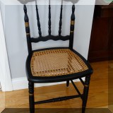 F21. Black painted caned side chair with stenciling. 34”h x 16”w x 15”d - $35